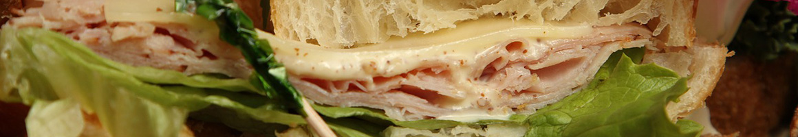 Eating Deli Sandwich at DiBella's Subs restaurant in Rochester, NY.
